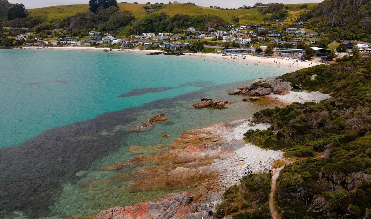 Aerial view of Boat Harbour Beach with white sand and turquoise water seen from a coastal headland, North West Tasmania