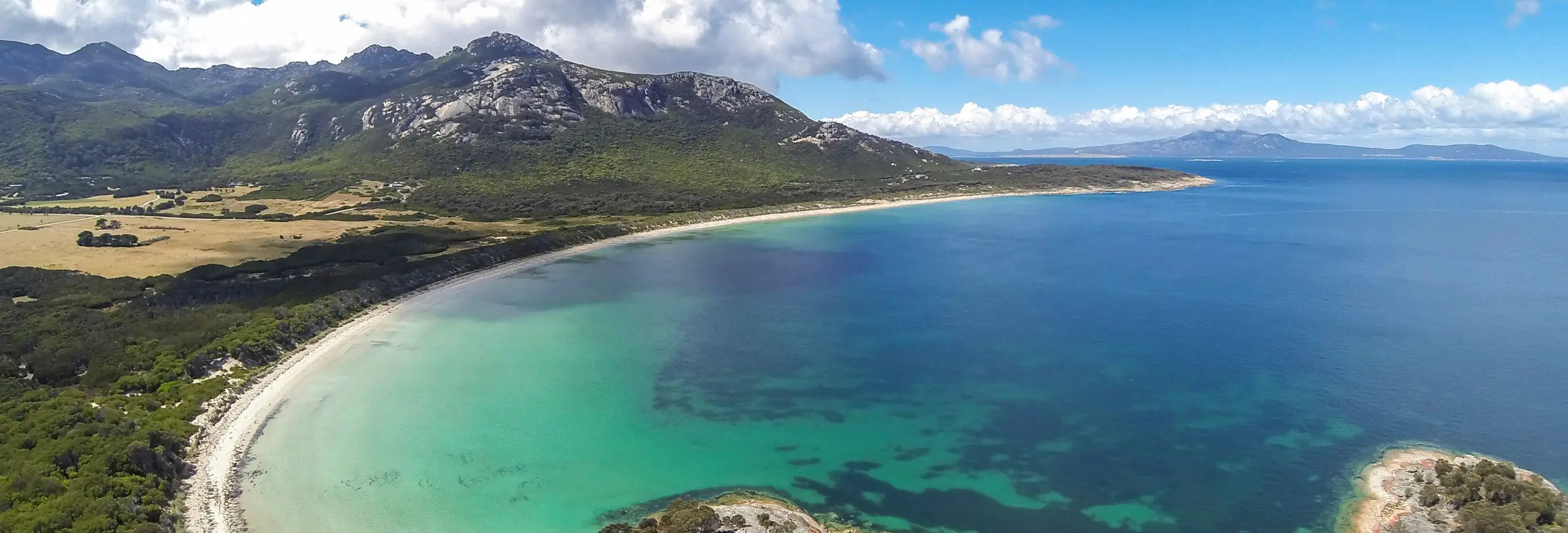 Aerial view of turquoise water and white sand at Trousers Point Beach in Strzelecki National Park on Flinders Island