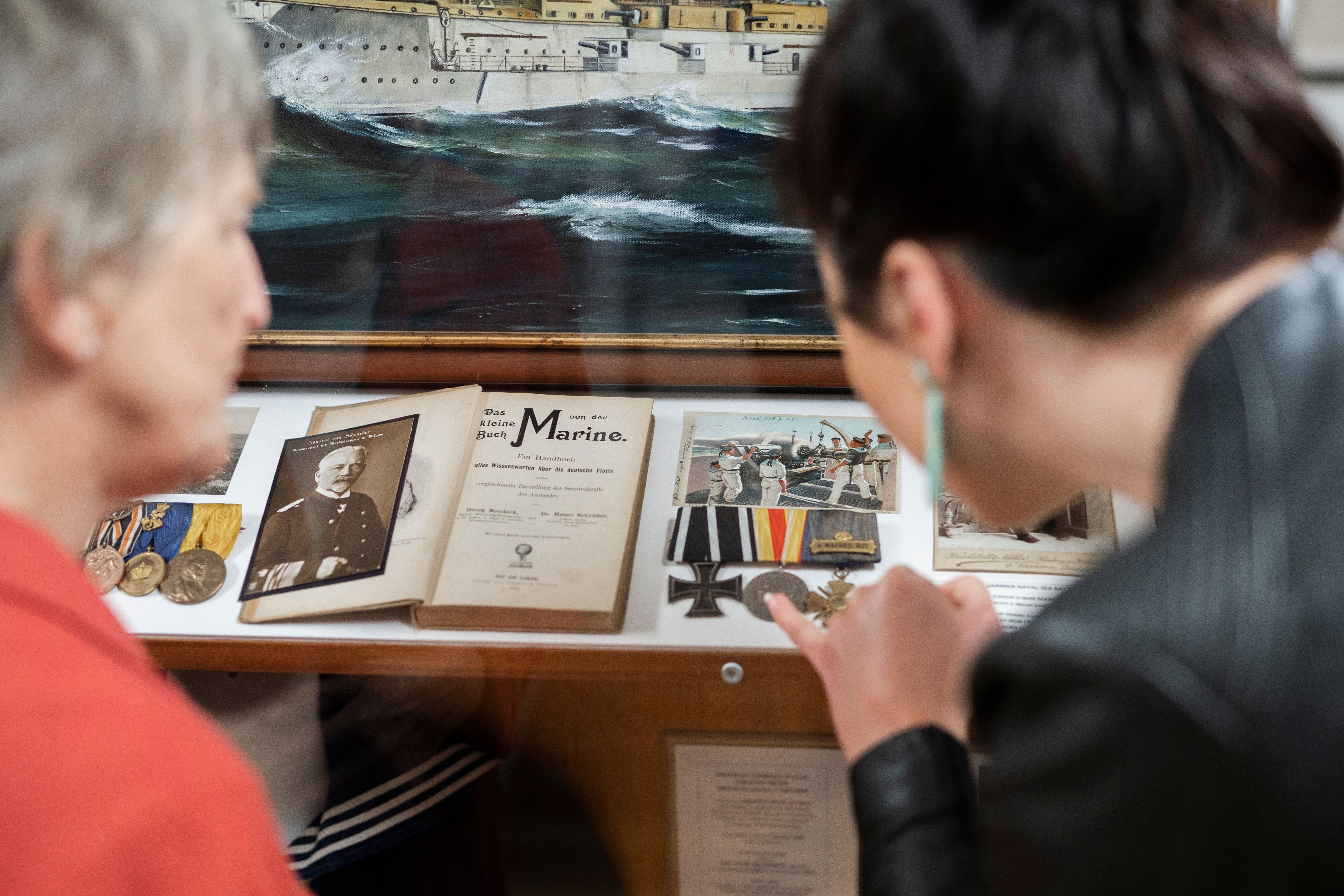 Visitors viewing naval artefacts in Mainly Maritime at Warship and Marine Corps Museum, St Helens, Tasmania