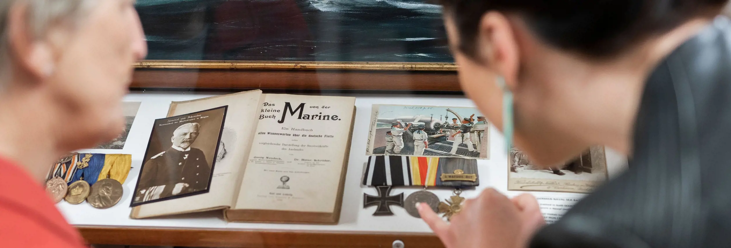 Visitors viewing naval artefacts in Mainly Maritime at Warship and Marine Corps Museum, St Helens, Tasmania