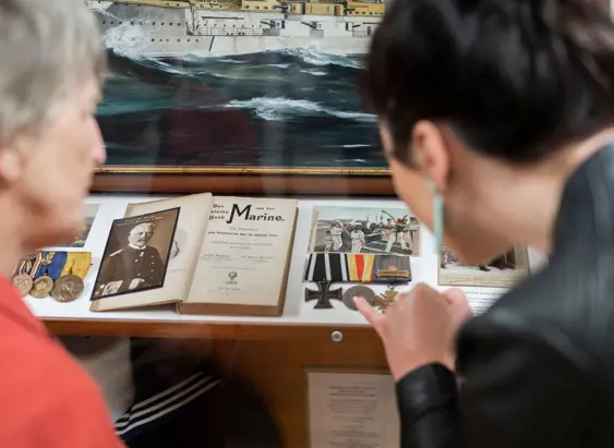 Visitors viewing naval artefacts in Mainly Maritime at Warship and Marine Corps Museum, St Helens, Tasmania