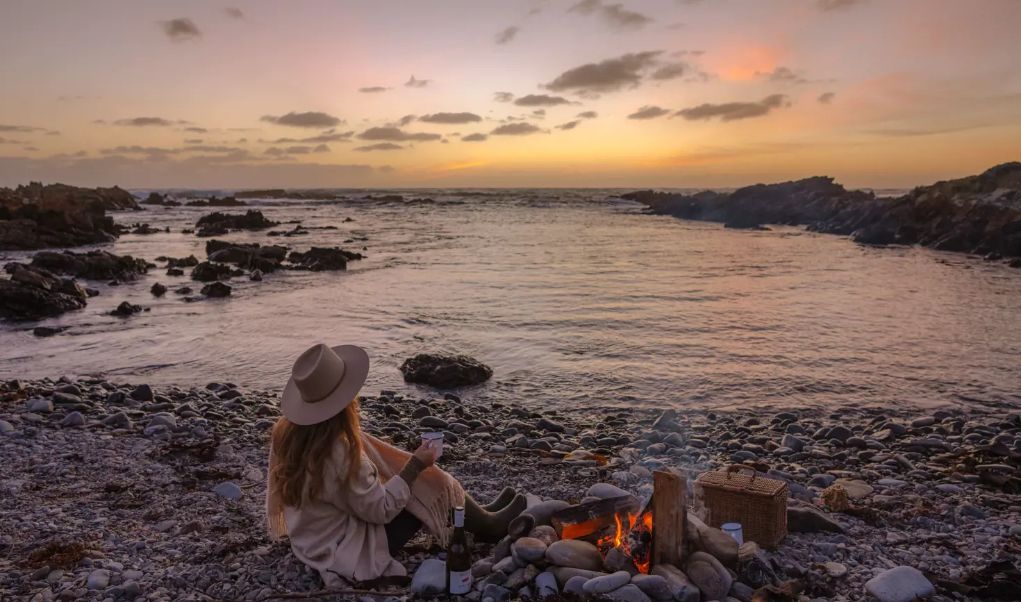A person on a beach beside a campfire on King Island, Tasmania