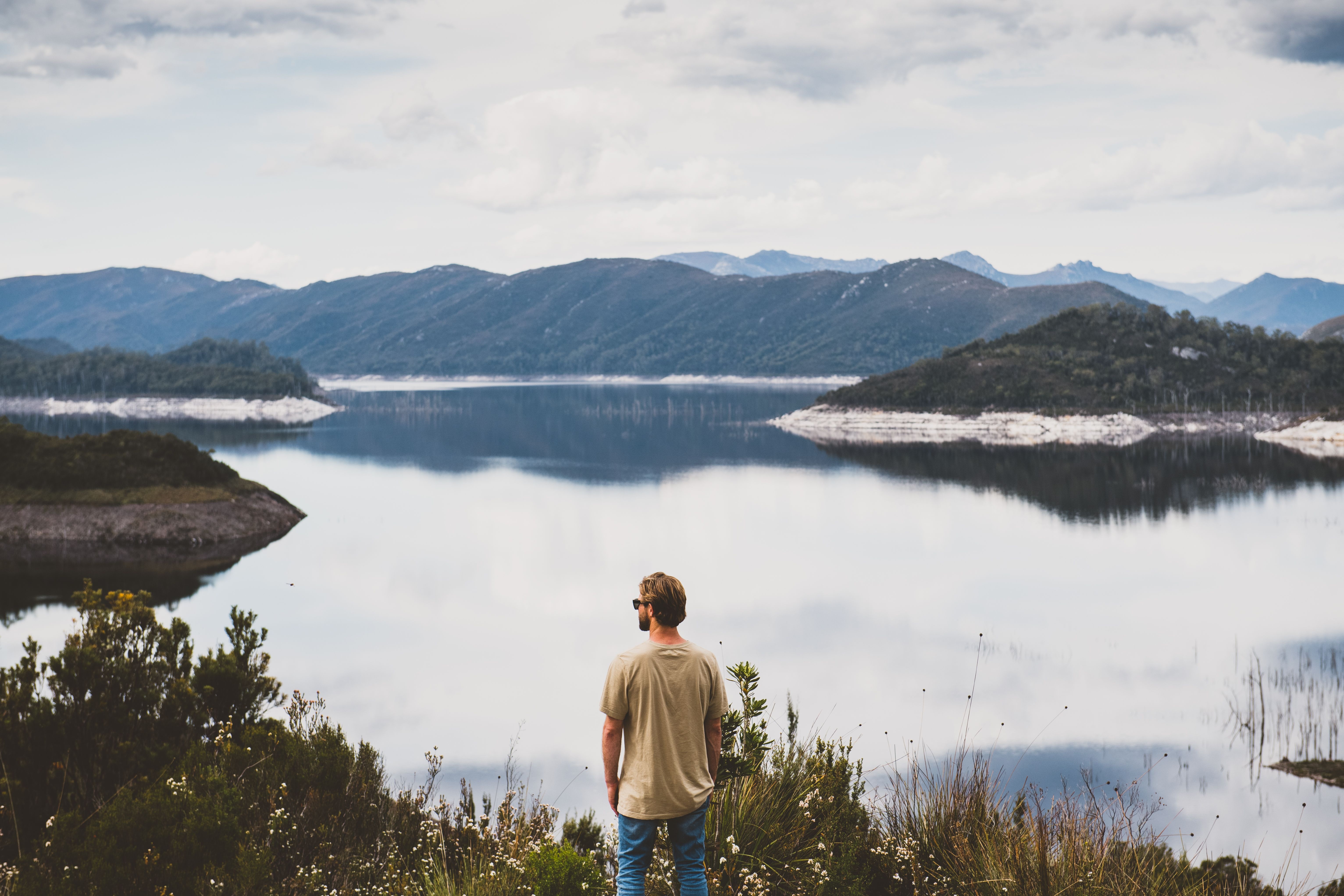 A person looking out over Lake Gordon with mountains in the distance, Strathgordon, Southwest National Park, Tasmania