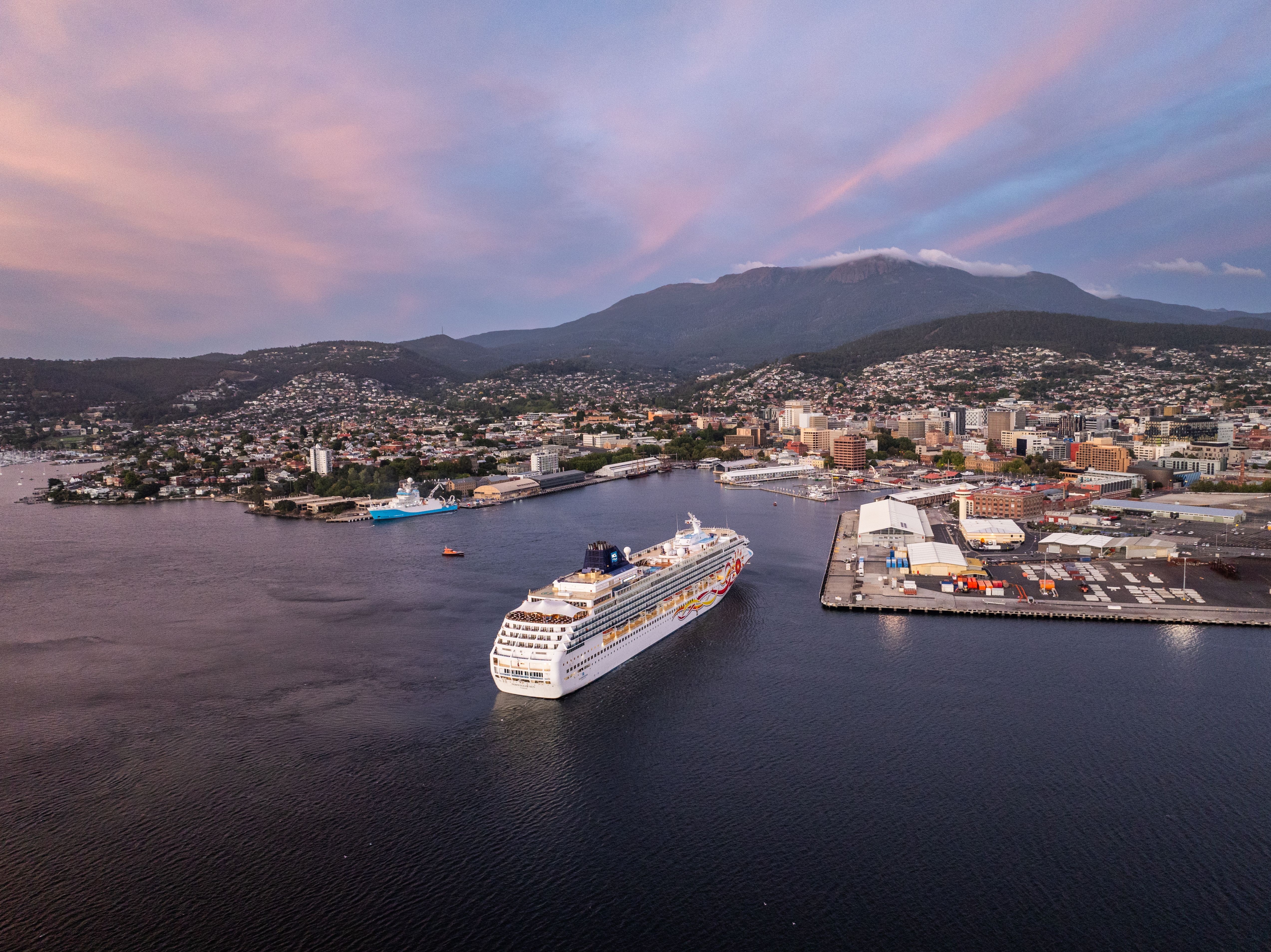 Aerial view of cruise ship Norwegian Sun arriving at Hobart Port with kunanyi / Mount Wellington in the background, Tasmania