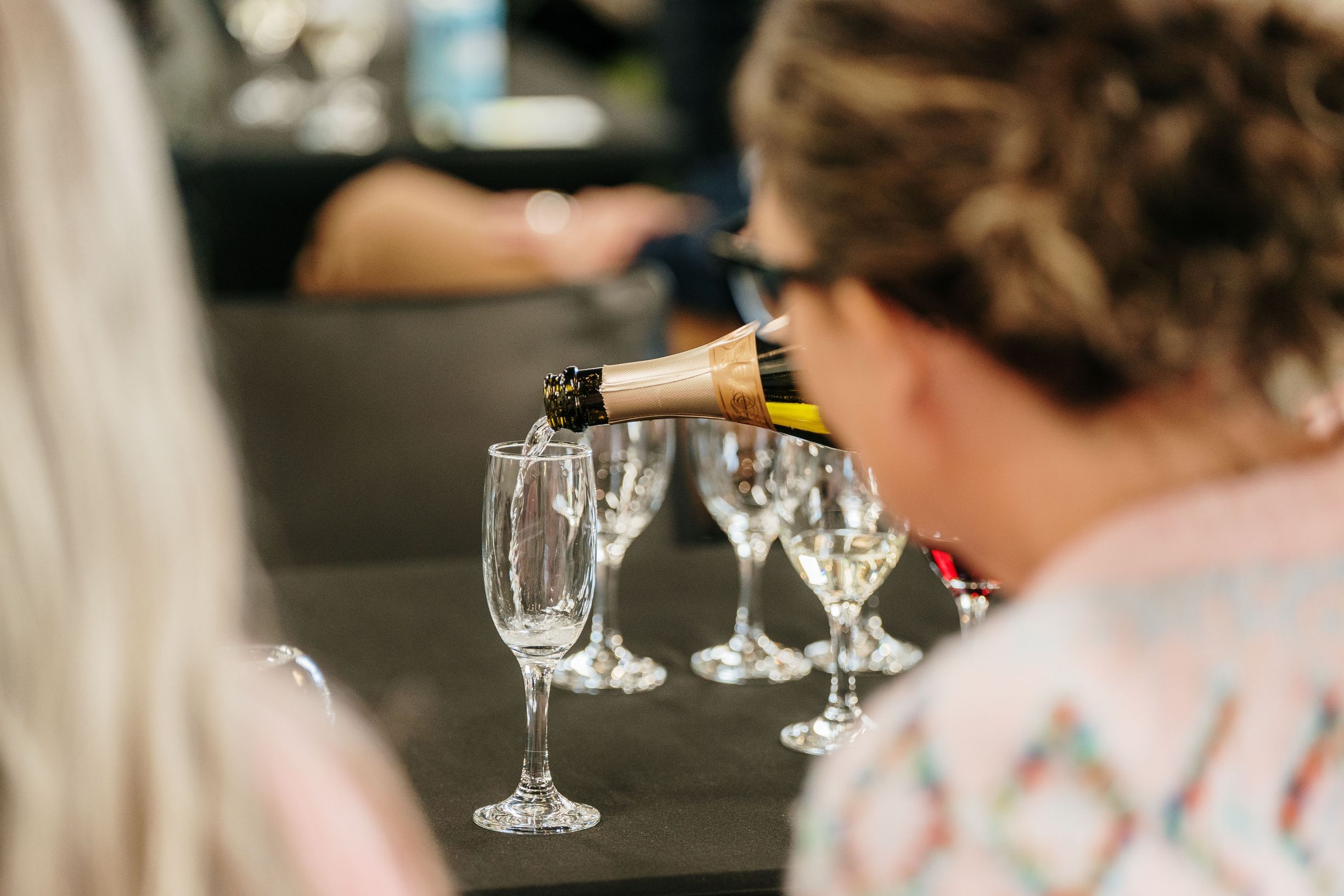 Sparkling wine being poured into glasses at Island Escape Festival