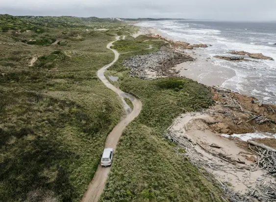 Aerial view of a Tall Timbers 4WD Adventure Tours vehicle on a coastal track, Smithton, takayna / Tarkine, Tasmania