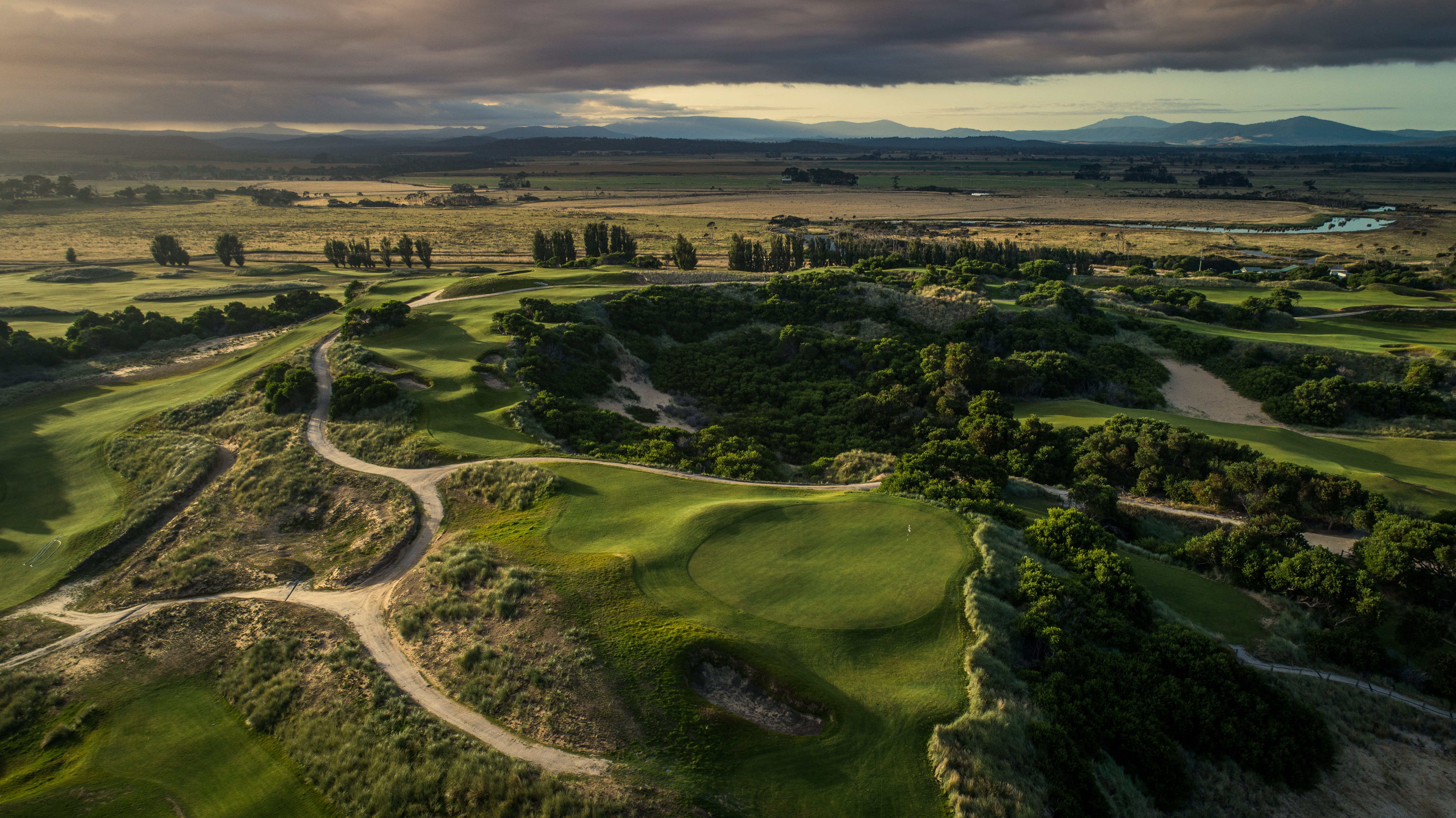 Aerial view of fairways and bunkers winding through coastal dunes at Barnbougle Dunes, Bridport, Tasmania