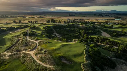 Aerial view of fairways and bunkers winding through coastal dunes at Barnbougle Dunes, Bridport, Tasmania