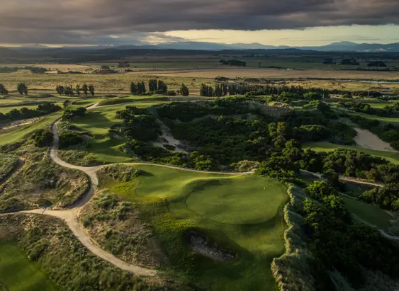 Aerial view of fairways and bunkers winding through coastal dunes at Barnbougle Dunes, Bridport, Tasmania