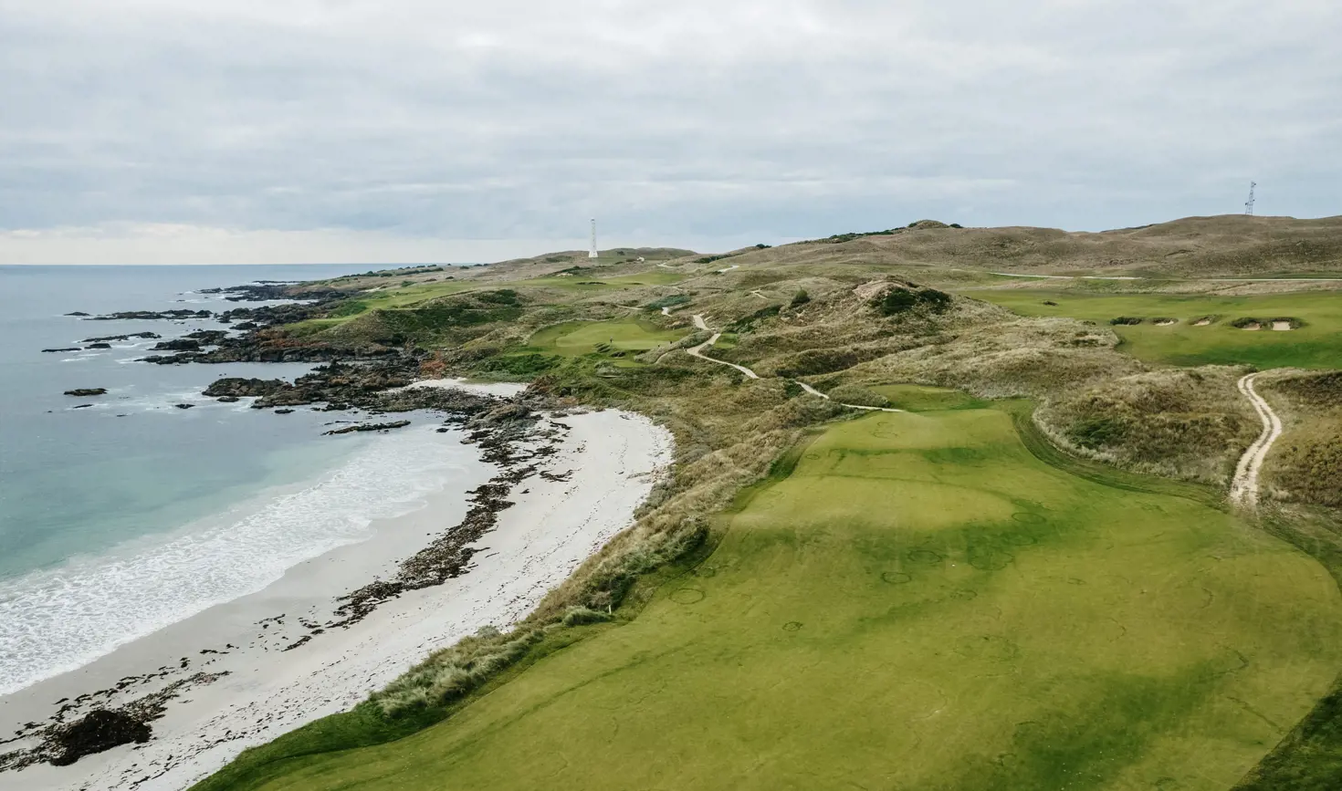 Aerial view of fairways alongside a beach and rugged coastline at Cape Wickham Golf Links, King Island, Tasmania