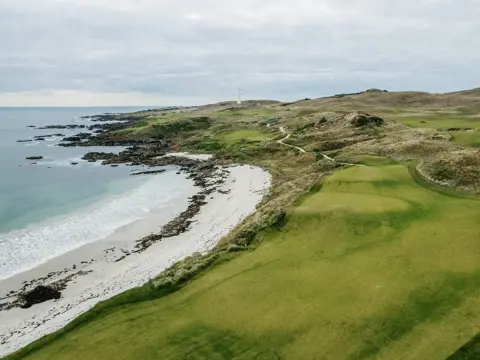 Aerial view of fairways alongside a beach and rugged coastline at Cape Wickham Golf Links, King Island, Tasmania
