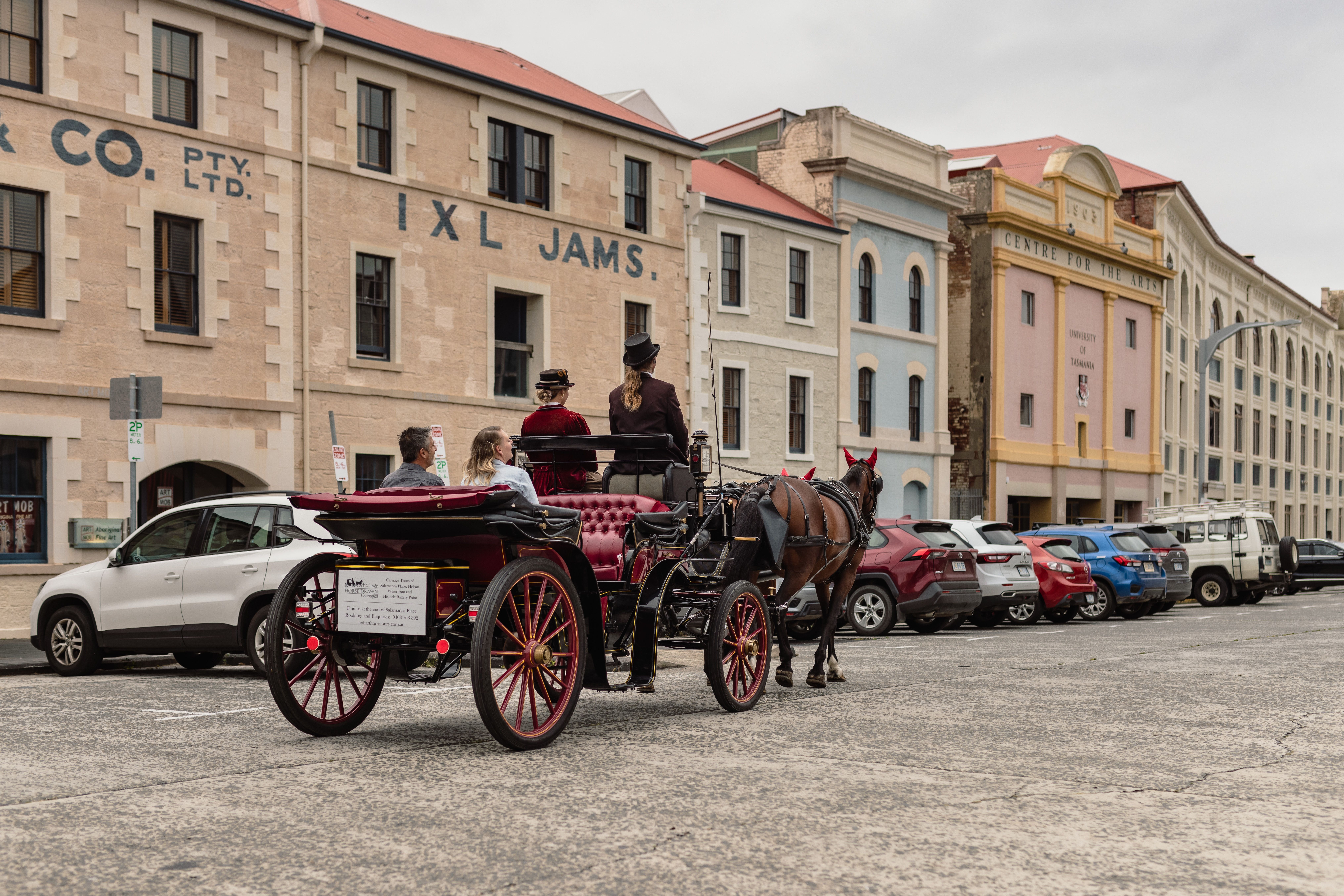 A Heritage Horse Drawn Carriages tour passing The Henry Jones Art Hotel on Hunter Street, Hobart, Tasmania