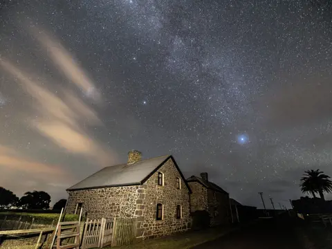 Heritage stone homestead beneath the Milky Way at Highfield Historic Site, Stanley, Tasmania