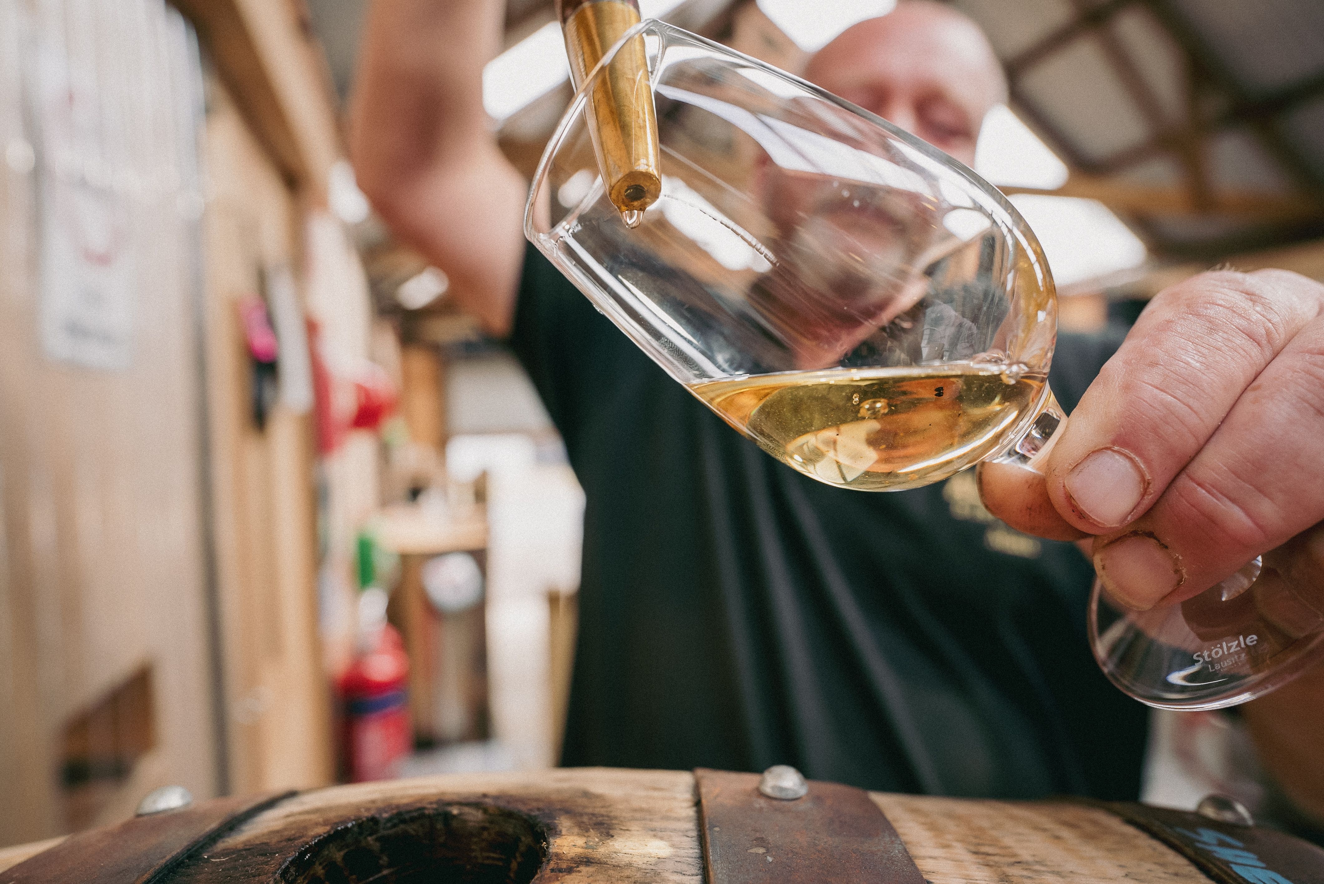 Whisky being poured into a tasting glass from a barrel at the Permission to Trespass event, Wynyard, Tasmania