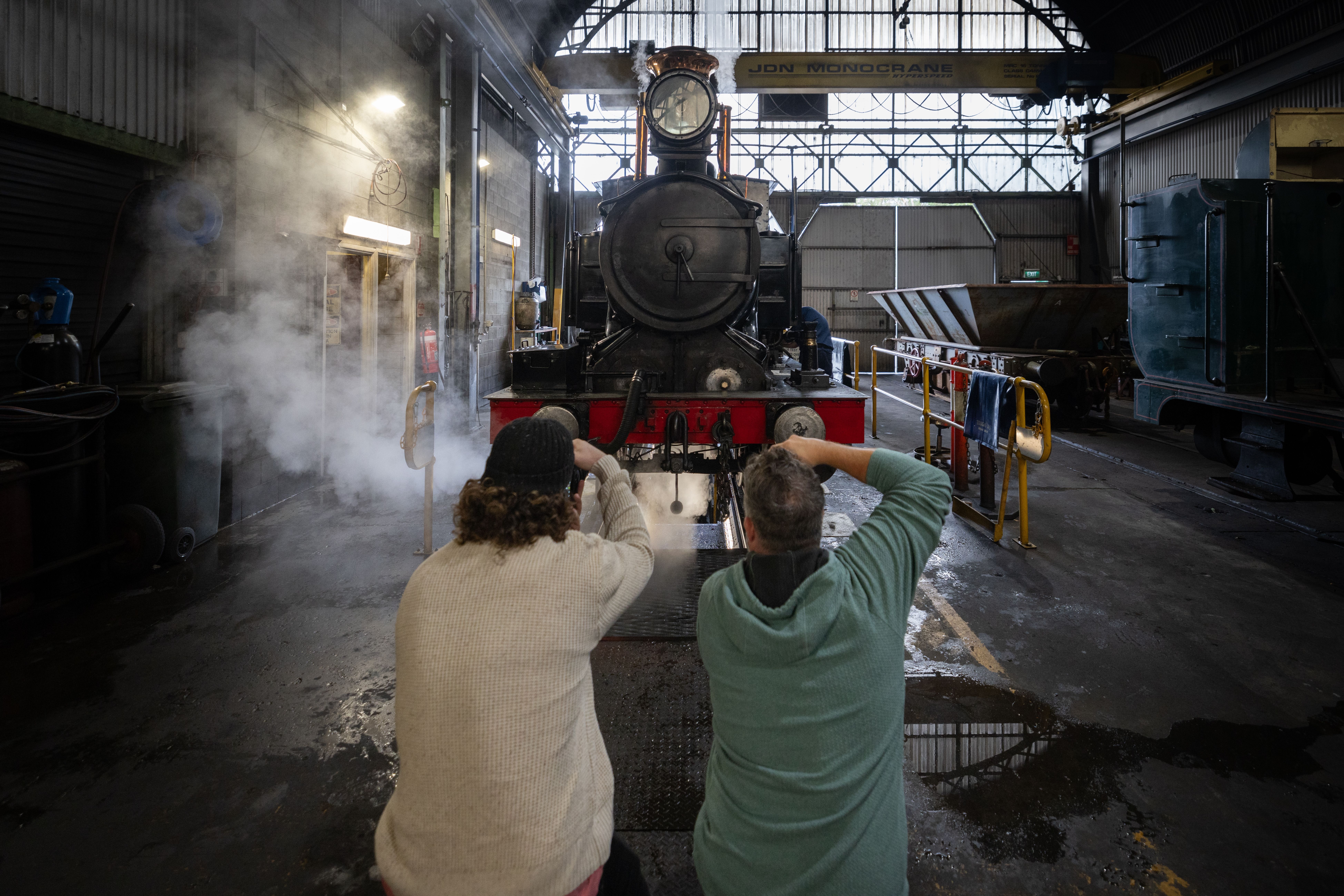 Photographers shooting a steam locomotive on West Coast Wilderness Railway's Steam Under the Stars, Queenstown, Tasmania