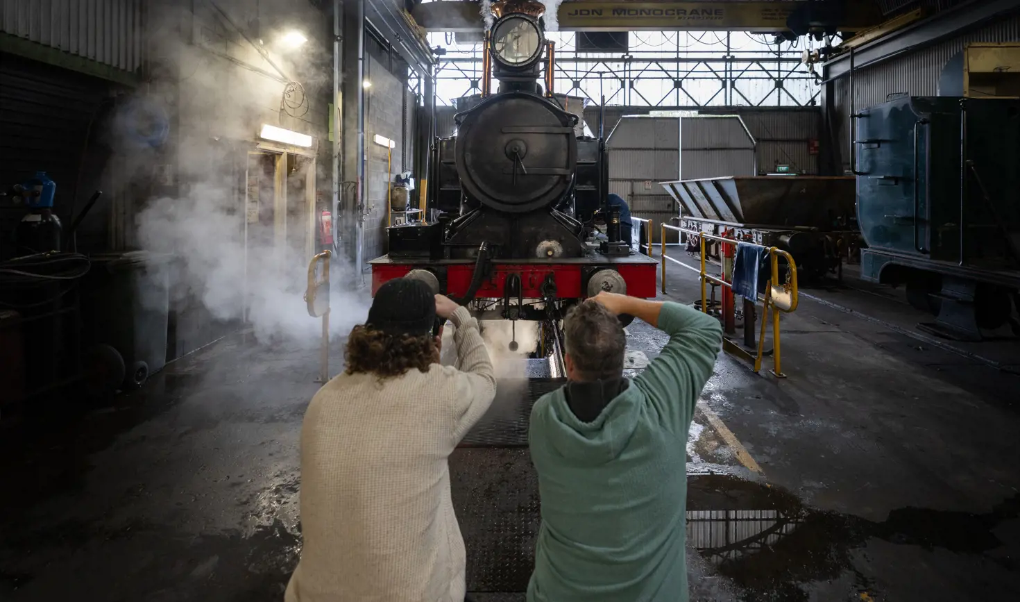 Photographers shooting a steam locomotive on West Coast Wilderness Railway's Steam Under the Stars, Queenstown, Tasmania