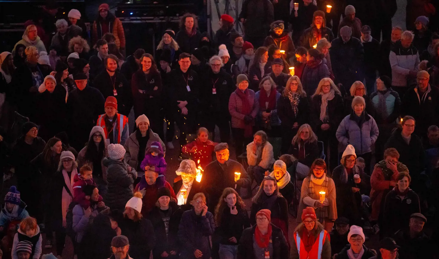 A crowd holding torches and candles at the Big Sing Bonfire during Festival of Voices, Hobart, Tasmania
