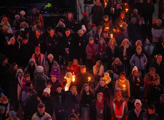 A crowd holding torches and candles at the Big Sing Bonfire during Festival of Voices, Hobart, Tasmania