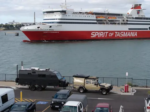 A 4WD towing a caravan in the queue to board the Spirit of Tasmania II ferry, Devonport, Tasmania