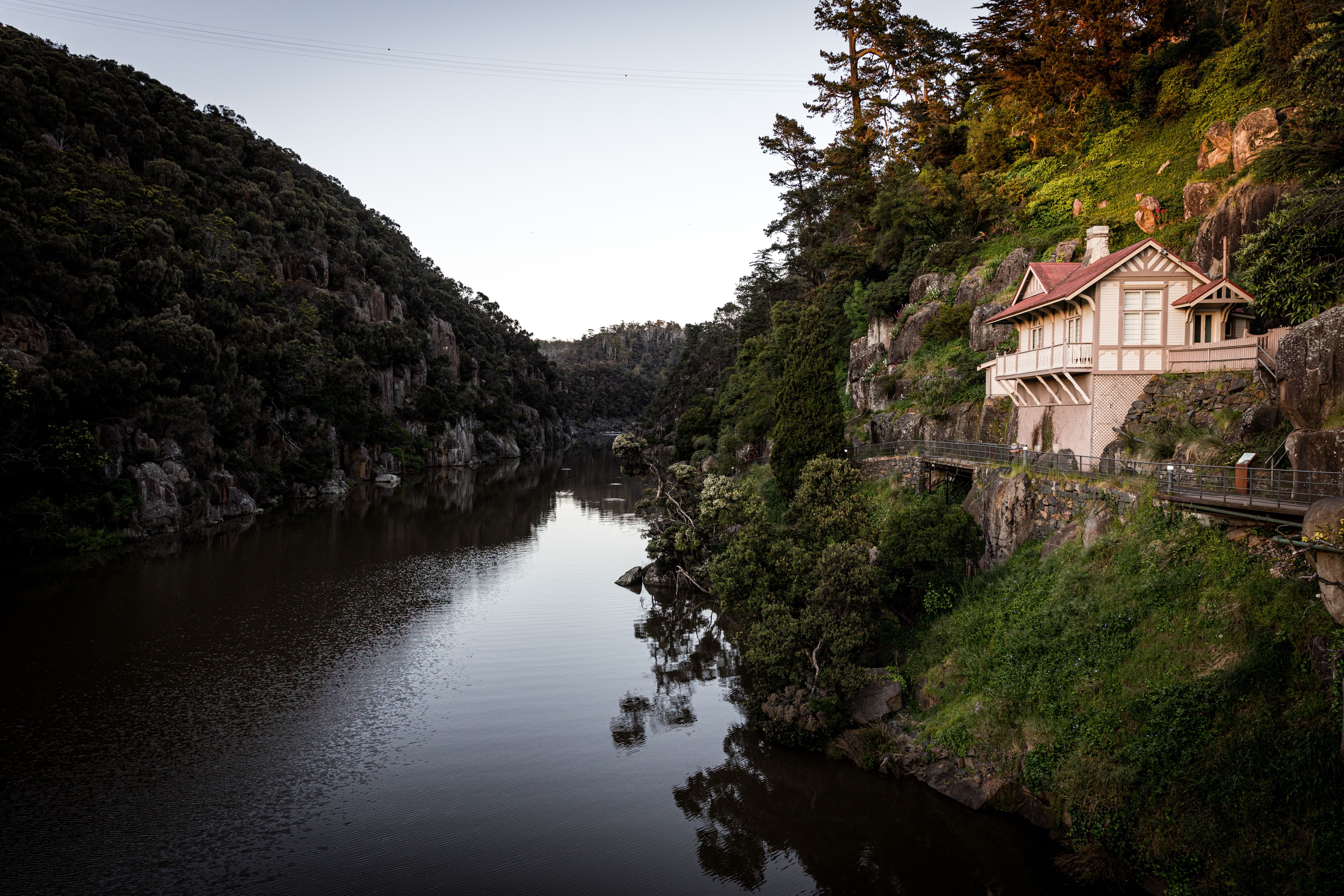 A heritage cottage on a rocky ledge above the river at Cataract Gorge Reserve, Launceston, Tasmania