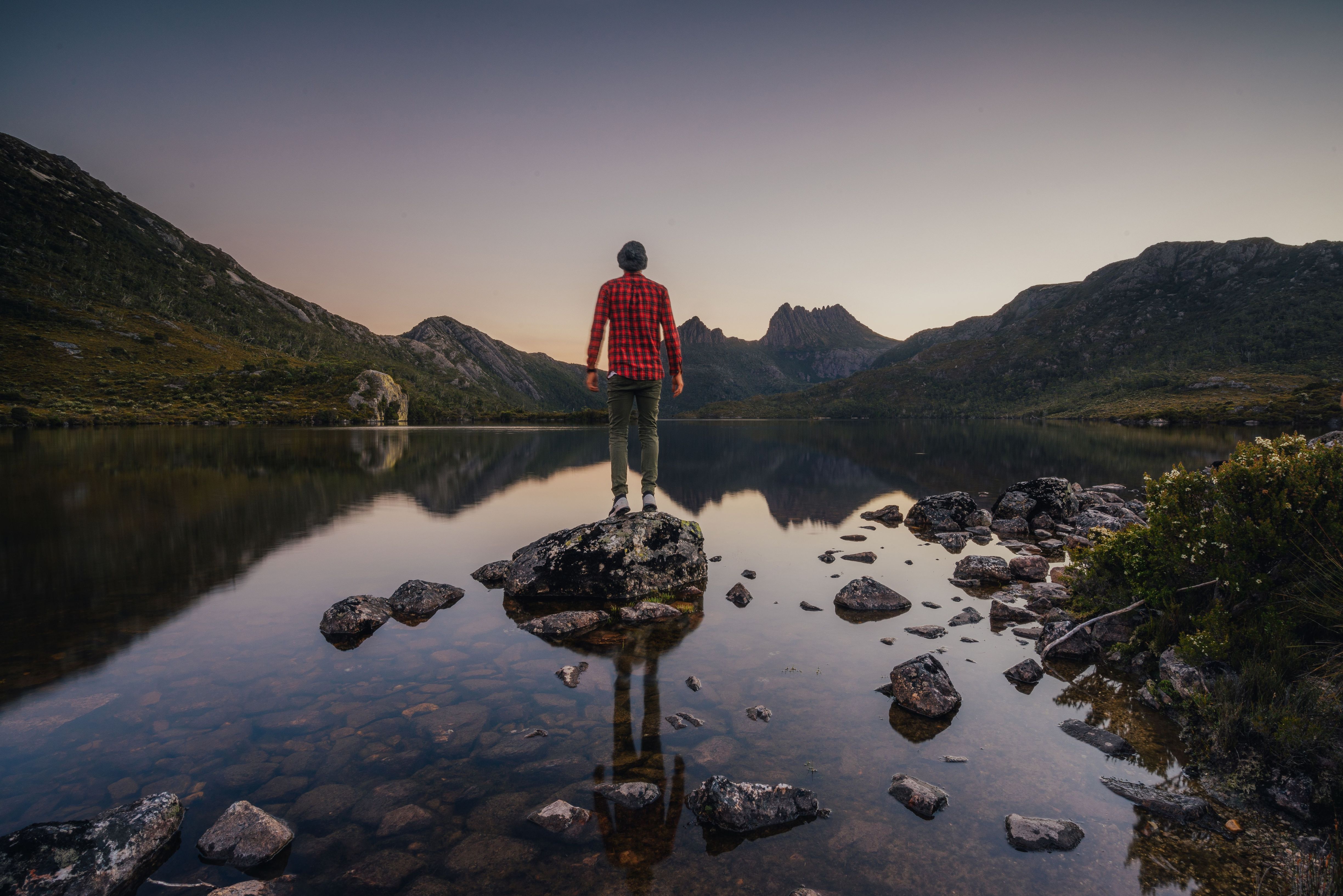 A person on a rock at Dove Lake looking to Cradle Mountain, Cradle Mountain-Lake St Clair National Park, Tasmania