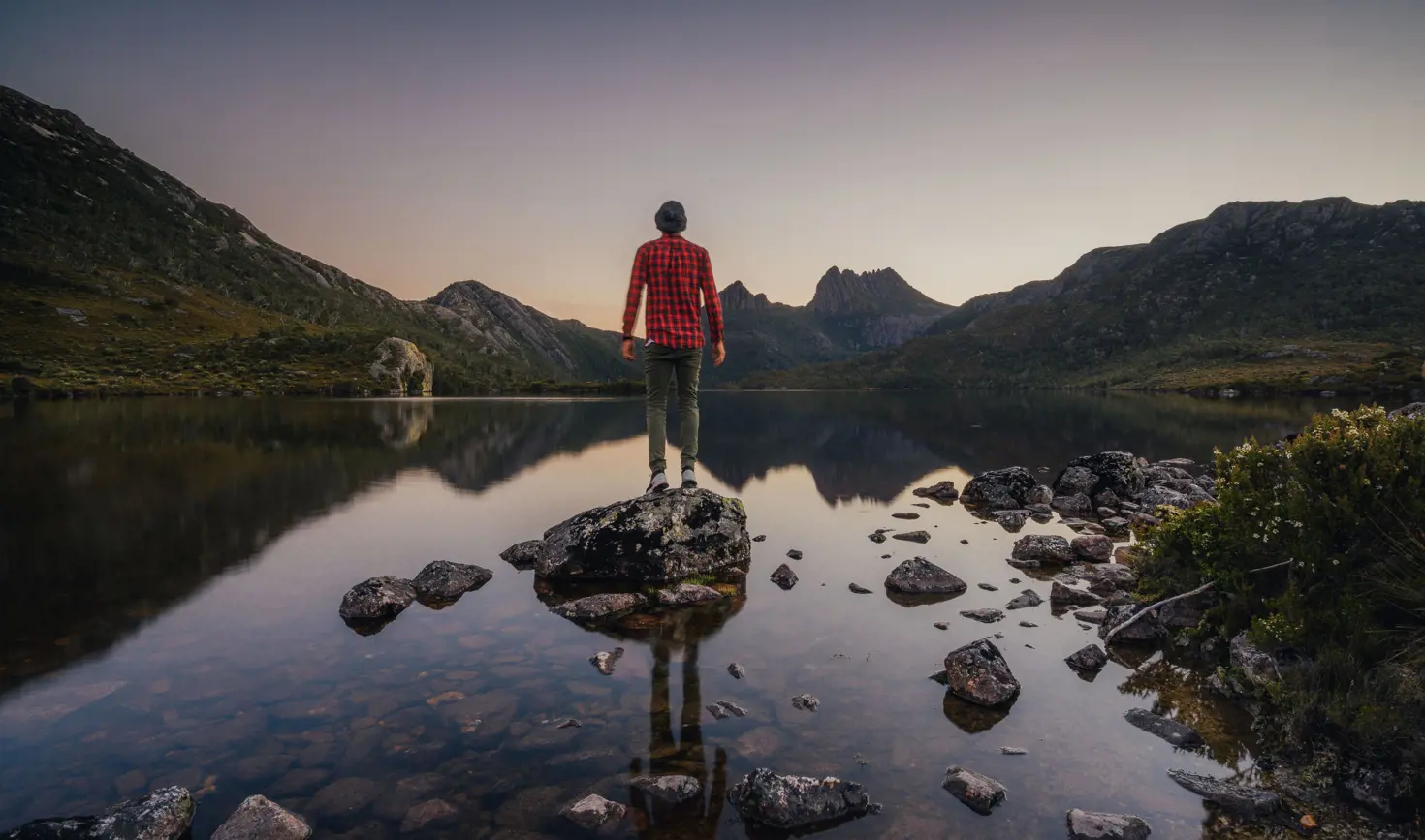 A person on a rock at Dove Lake looking to Cradle Mountain, Cradle Mountain-Lake St Clair National Park, Tasmania