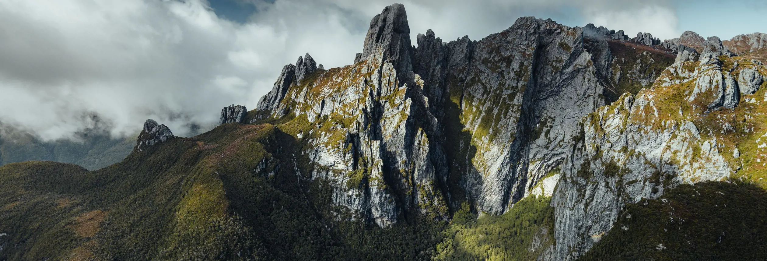 Aerial view of Federation Peak's jagged quartzite spires above tarns and wilderness, Southwest National Park