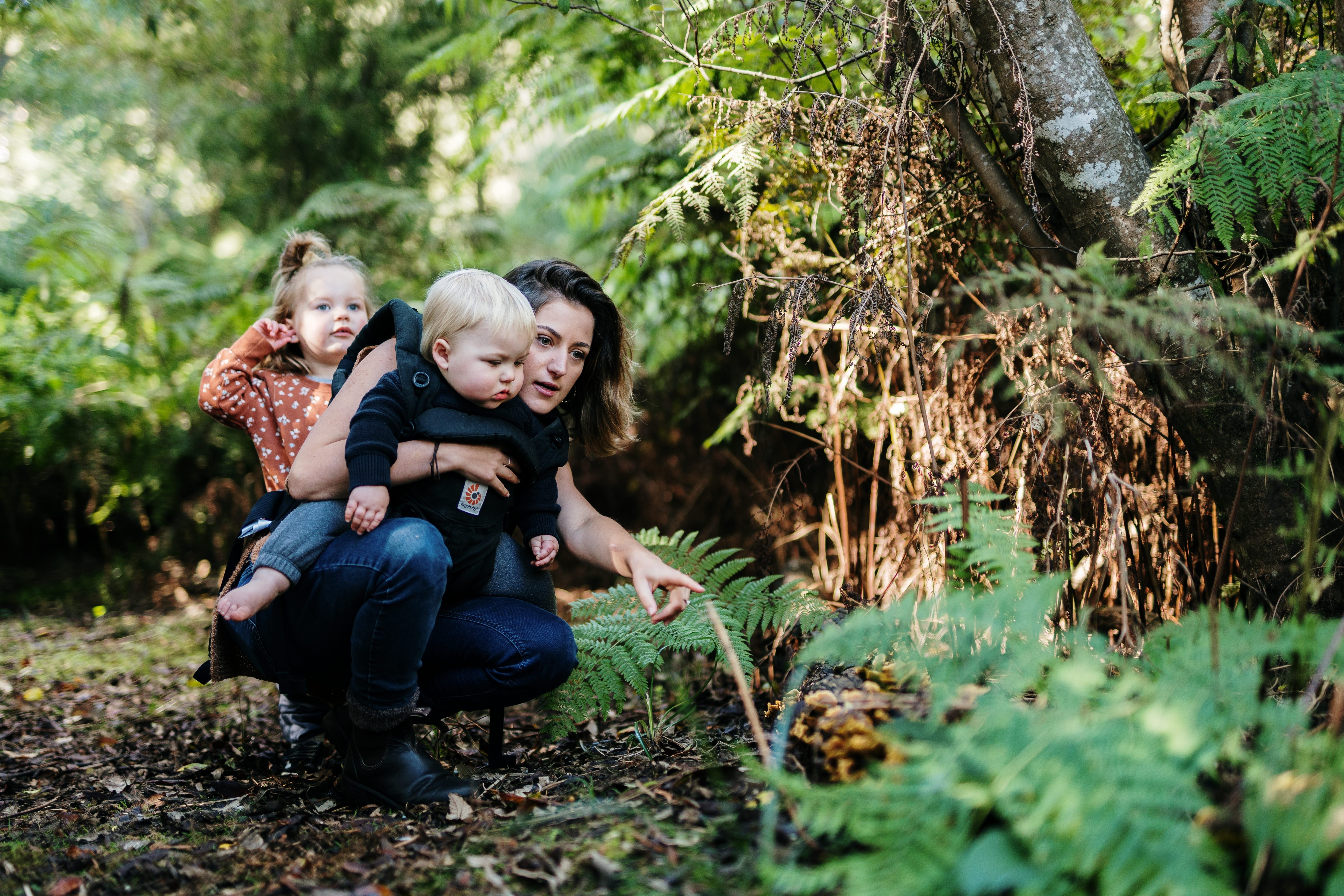 A mother and two young children exploring flora in Leven Park on a Leven River Cruises tour, Ulverstone