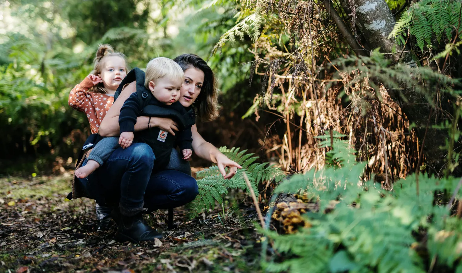 A mother and two young children exploring flora in Leven Park on a Leven River Cruises tour, Ulverstone