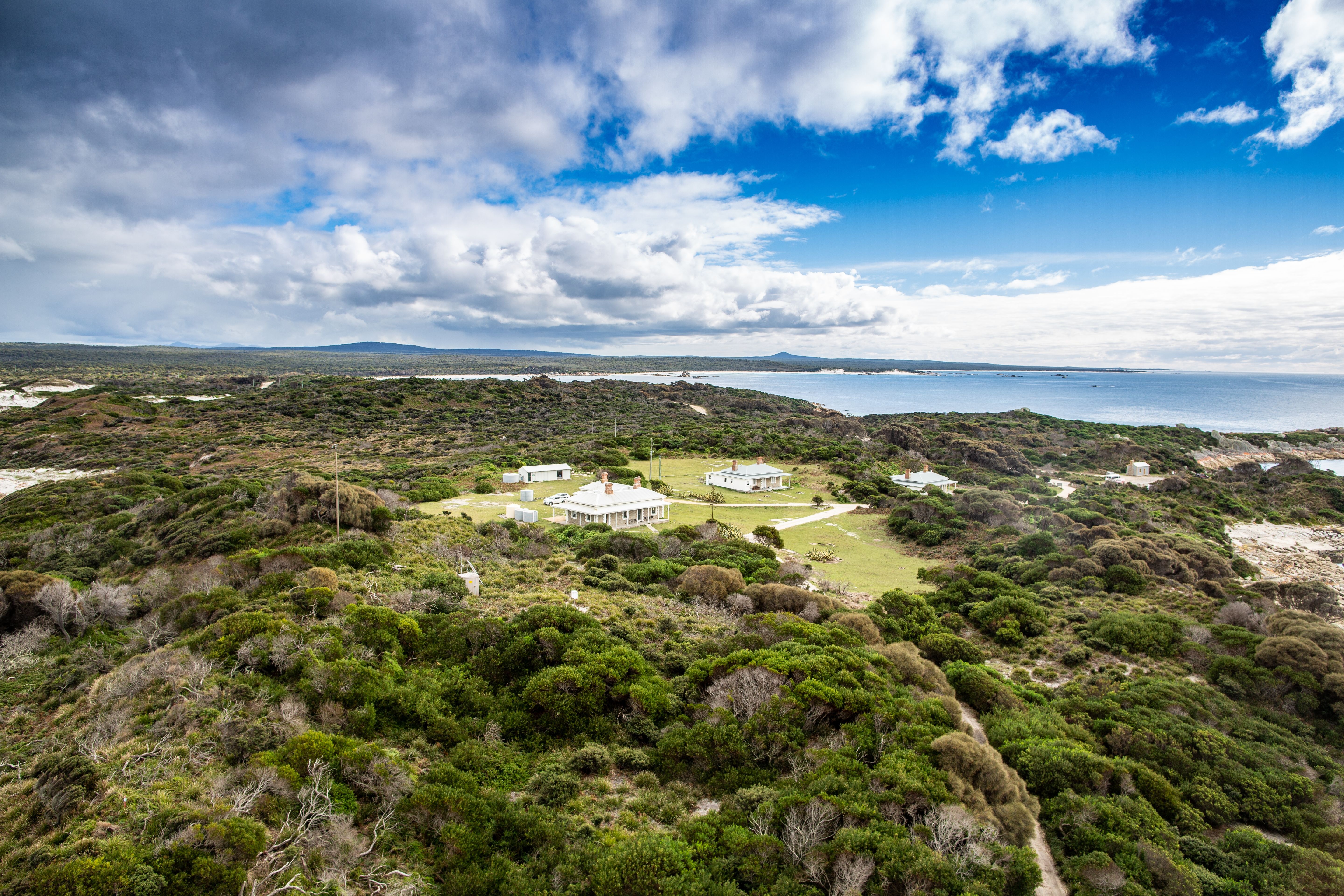 Aerial view of the heritage lightkeepers cottages used by wukalina Walk at Eddystone Point, larapuna / Bay of Fires area