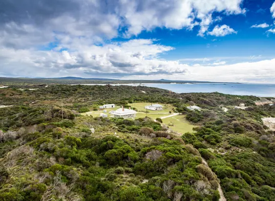 Aerial view of the heritage lightkeepers cottages used by wukalina Walk at Eddystone Point, larapuna / Bay of Fires area