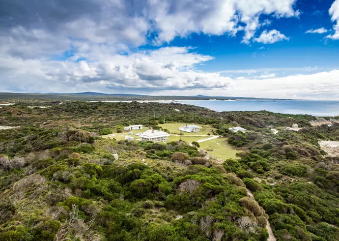 Aerial view of the heritage lightkeepers cottages used by wukalina Walk at Eddystone Point, larapuna / Bay of Fires area