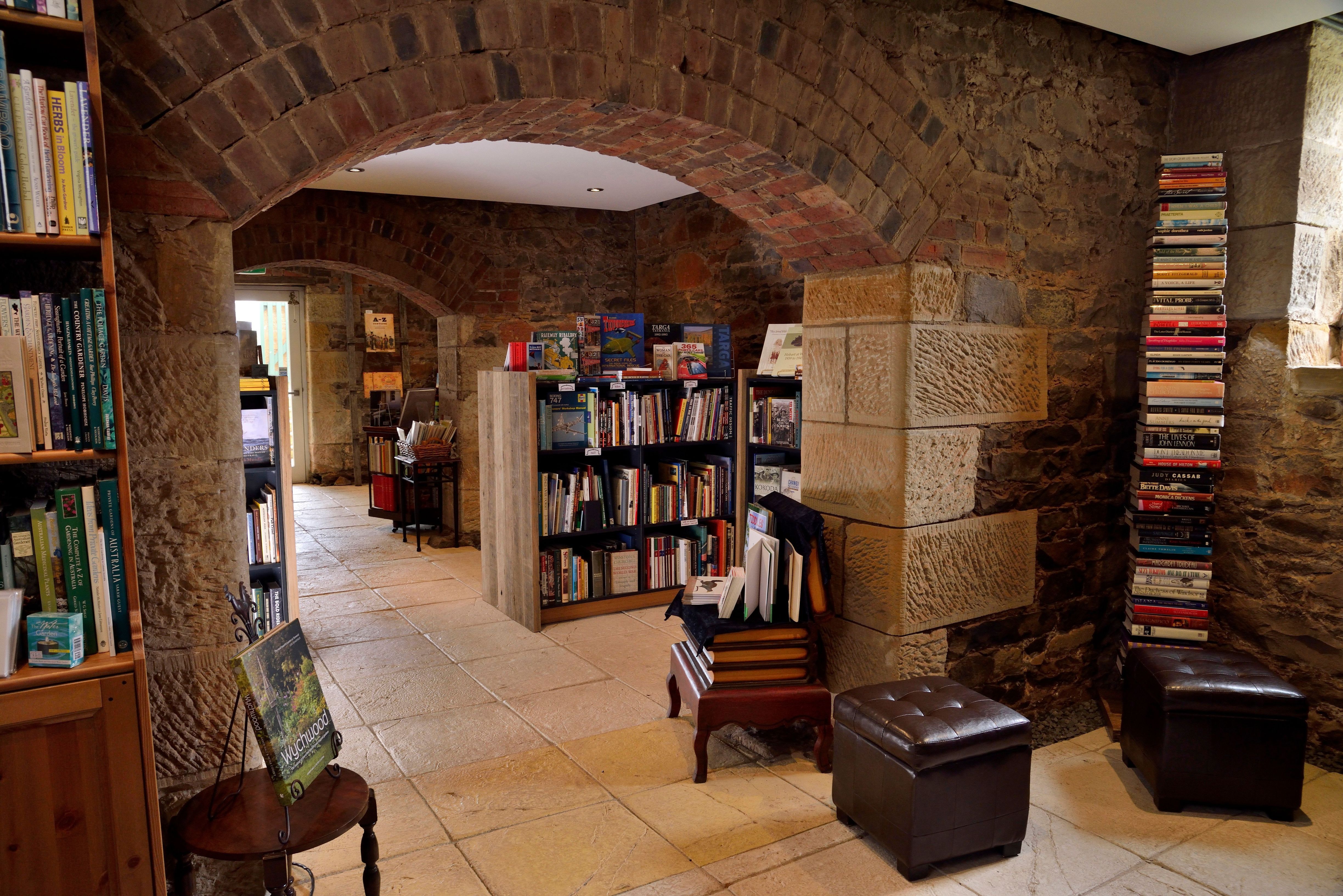 Bookshelves lining the convict-built sandstone and brick arched cellars of The Book Cellar bookshop in Campbell Town