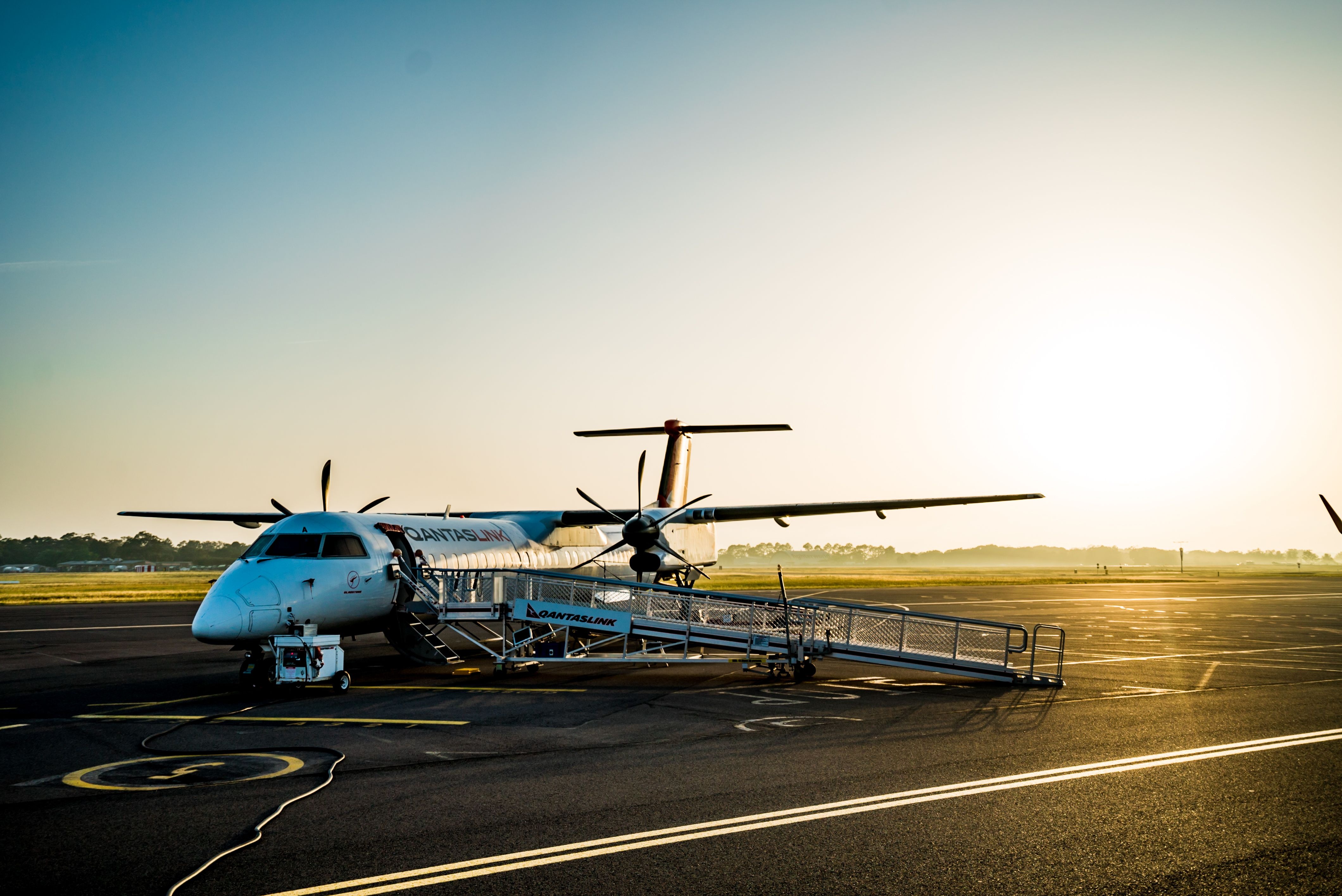 A QantasLink regional aircraft with airstairs deployed on the tarmac at Launceston Airport
