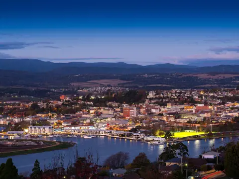 Elevated view of Launceston city lights and the kanamaluka / River Tamar at twilight, northern Tasmania