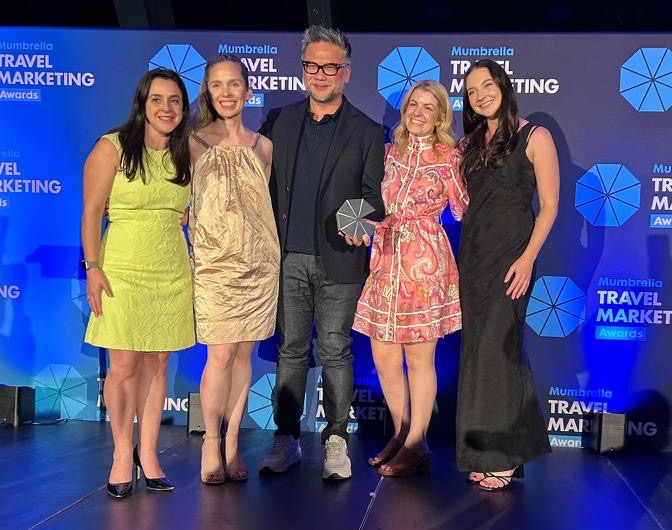 Award winners holding the PR Idea of the Year trophy for the Odd Jobs campaign at the Mumbrella Travel Marketing Awards