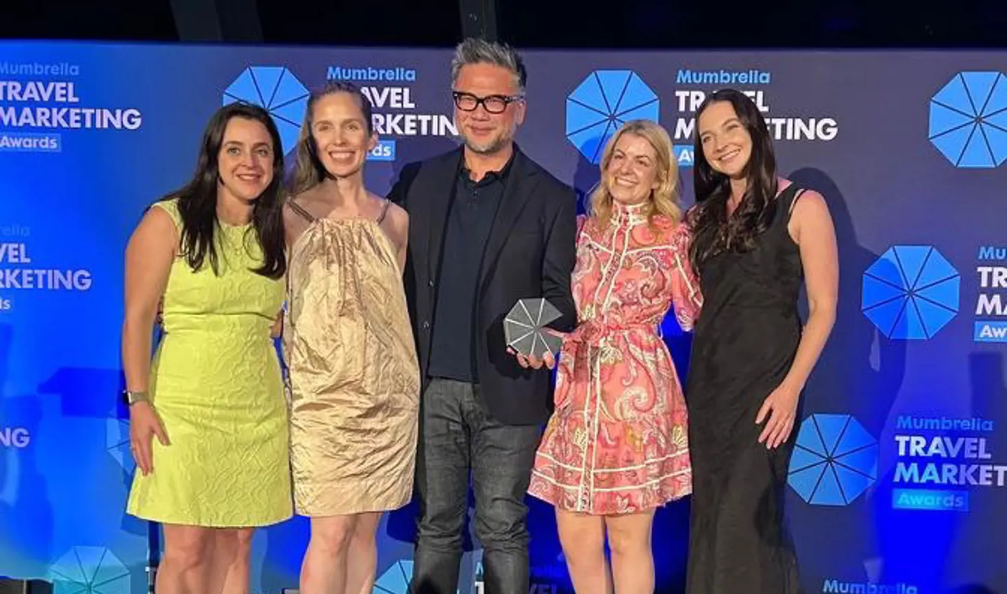 Award winners holding the PR Idea of the Year trophy for the Odd Jobs campaign at the Mumbrella Travel Marketing Awards