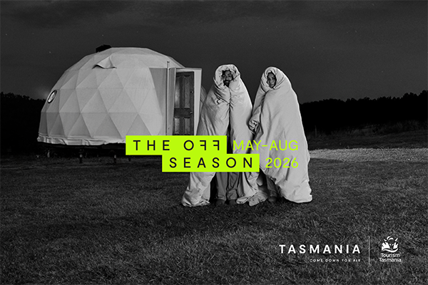 Tourism Tasmania Off Season campaign image with two people wrapped in blankets beside a glamping dome, May to August 2026