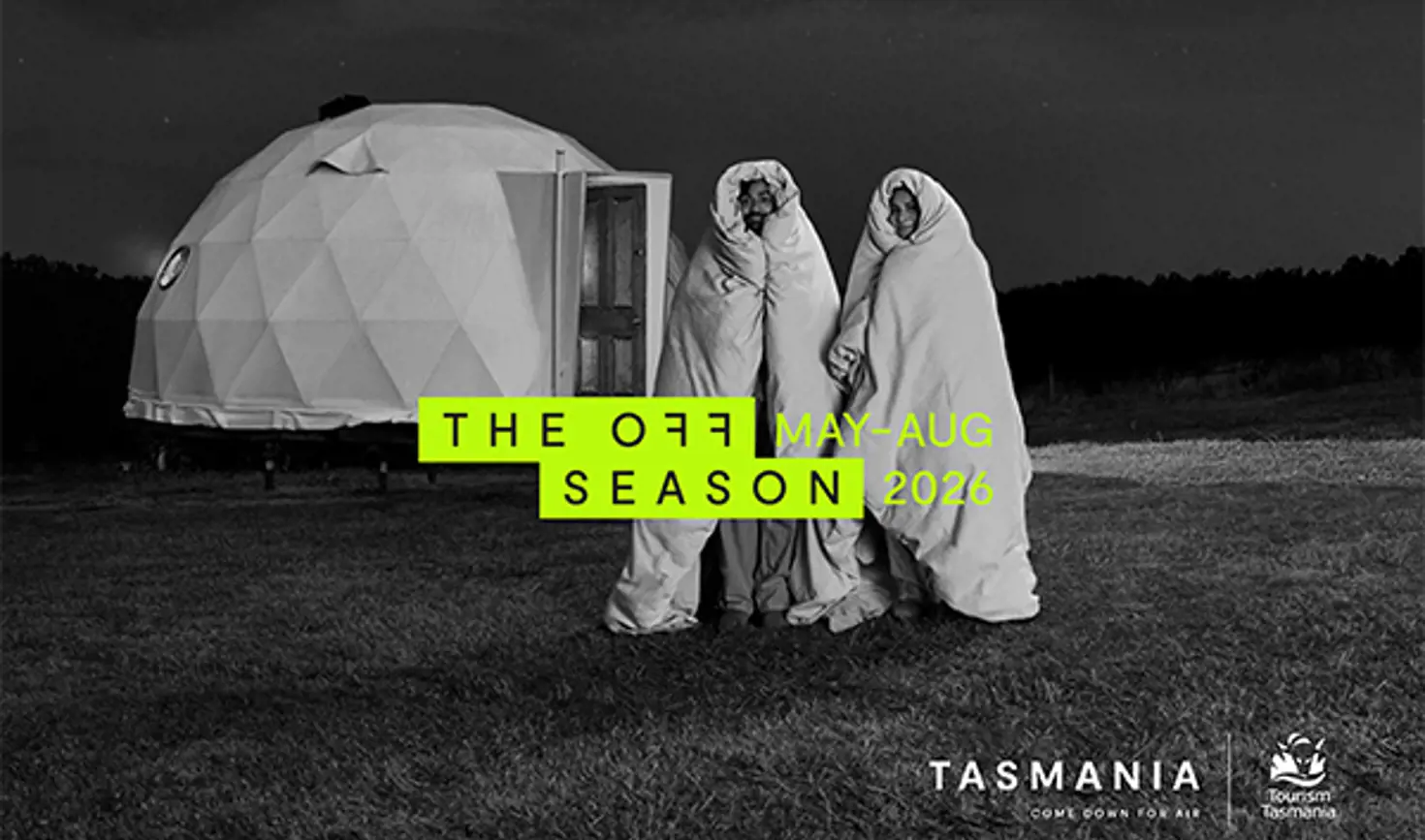 Tourism Tasmania Off Season campaign image with two people wrapped in blankets beside a glamping dome, May to August 2026