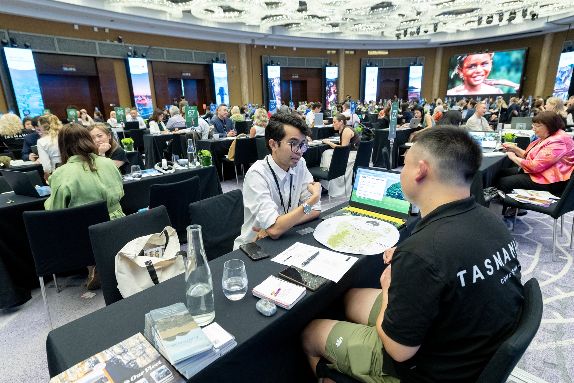 Tourism operator presenting a Tasmania itinerary on a laptop to a buyer at an Australia Marketplace event