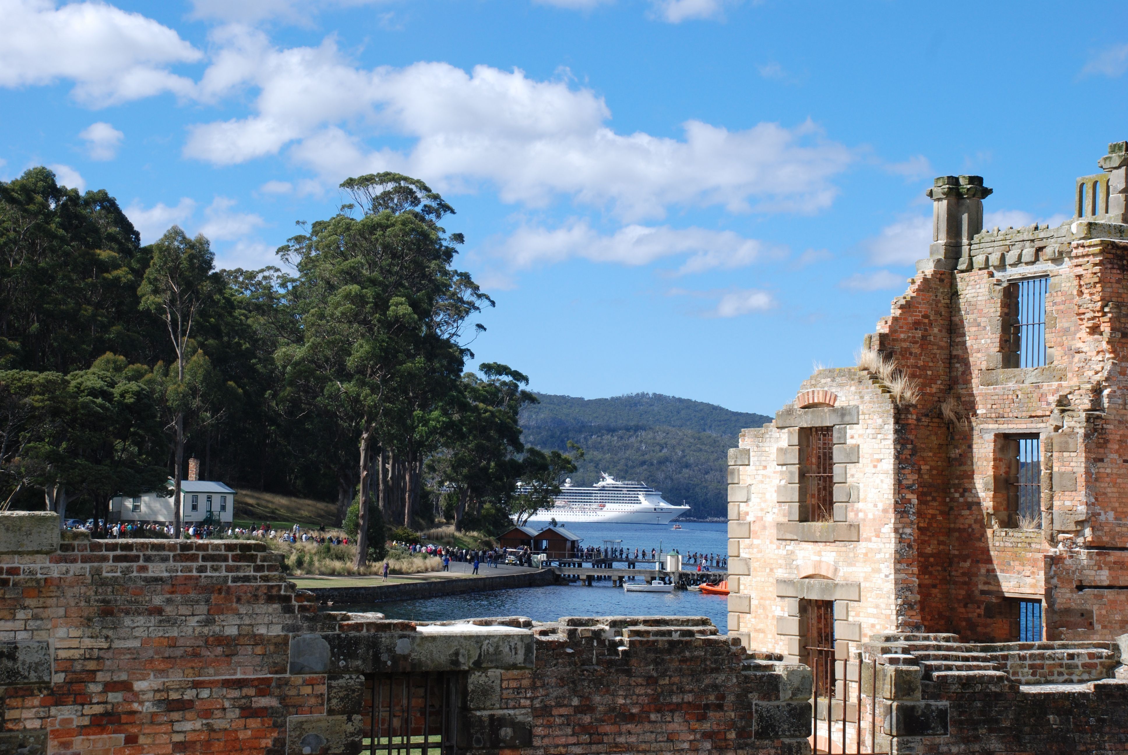 Brick ruins overlooking the jetty and a cruise ship at Port Arthur Historic Site, Turrakana / Tasman Peninsula