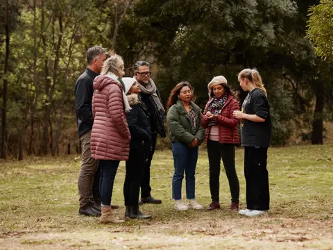 Visitors listen to a guide during a kipli takara tour with palawa kipli, Risdon Cove