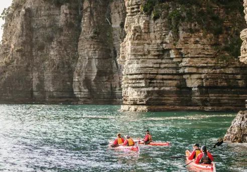 Sea kayakers paddle along dramatic coastal cliffs at Turrakana / Tasman National Park with Southern Sea VentureSea kayakers paddle along dramatic coastal cliffs at Turrakana / Tasman Peninsula with Southern Sea Ventures