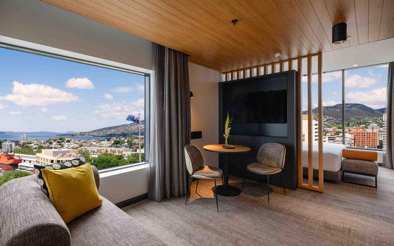 The modern interior of this room at the Movenpick Hoteloverlooks Hobart and the waterfront on a clear, sunny day