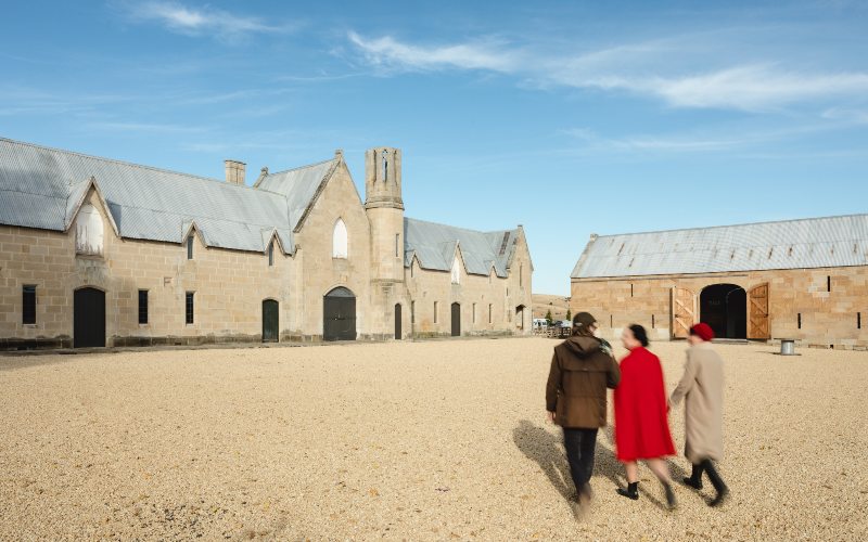 # people walk across the gravel courtyard at historic Shene Distillery, Tasmania