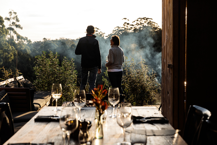 a couple viewing outside with wine glasses